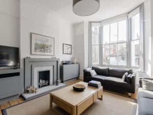 a living room with a couch and a fireplace at 4 bed property in Broadstairs 80679 in Broadstairs