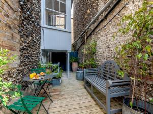 a patio with a bench and a table and a building at 4 bed property in Broadstairs 80679 in Broadstairs