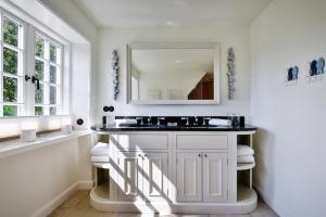 a bathroom with a sink and a mirror at Daluja in Keitum +29 photos