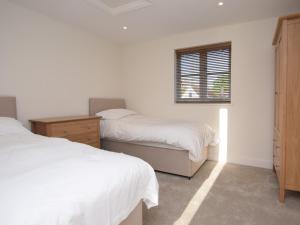 a bedroom with two beds and a window at 2 bed in Sherborne 80735 in Wootton Glanville