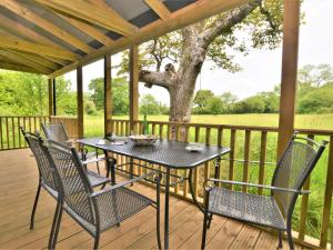 a patio with a table and chairs on a deck at 2 bed in Sherborne 80735 in Wootton Glanville