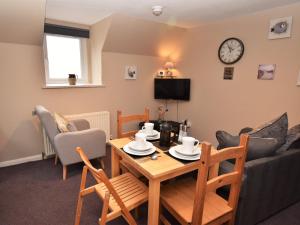 a living room with a table and a couch at 2 Bed in Cosheston FB059 in Cosheston