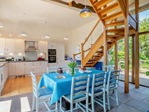 a kitchen and dining room with a table and chairs at 4 Bed in Talgarth BN182 in Talgarth