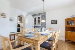 a dining room with a wooden table and chairs at Paulas Hues Paula in Keitum +17 photos
