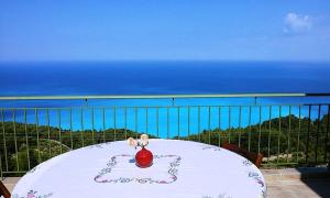 a red ball sitting on a table on a balcony at Porto Katsiki Blu in Athani