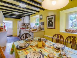 a kitchen and dining room with a table and chairs at 4 Bed in Llangynidr BN305 in Llangynidr