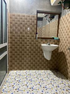 a bathroom with a sink and a tiled floor at Ha Giang Lake View House in Ha Giang