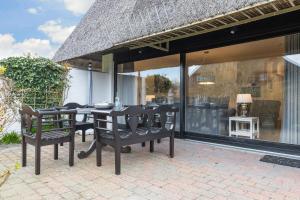 a dining table and chairs on a patio at Uaster Reeg I Parterrewohnung in Archsum