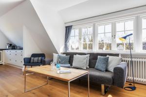 a living room with a couch and a table at Blue Haven in Keitum