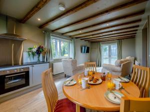 a kitchen and dining room with a wooden table at 2 Bed in Bentham 82857 in High Bentham