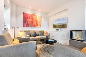 a living room with a couch and a fireplace at Traumblick Sylt in Rantum