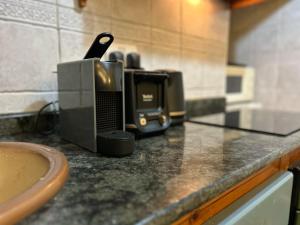 a kitchen counter with a coffee maker on it at Central Valletta Townhouse with Maltese Balcony in Valletta