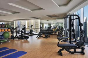 a gym with treadmills and exercise equipment in a building at Address Marina Suites in Dubai