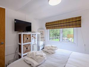 a bedroom with two white towels on a bed at 2 Bed in Woodgreen 82875 in Godshill