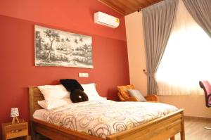 Santa Monica Home Lodge في Senchi: غرفة نوم مع سرير مع دمية دب عليها