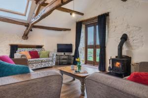 a living room with a wood stove in a room at 3 Bed in Eden Valley SZ400 in Kirkoswald