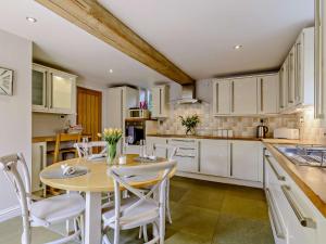 a kitchen with a wooden table and white cabinets at 2 Bed in Lightcliffe 83521 in Halifax