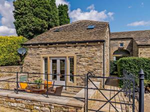 a stone house with a porch and a patio at 2 Bed in Lightcliffe 83521 in Halifax