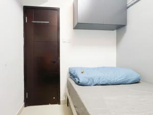 a small room with a bed and a closet at Student Accommodation - 5 Man Cheong Street in Hong Kong