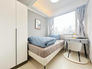 a small bedroom with a bed and a window at Student Accommodation - 5 Man Cheong Street in Hong Kong