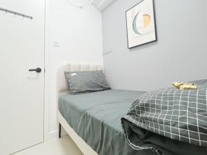 a small bedroom with a bed and a closet at Student Accommodation - 5 Man Cheong Street in Hong Kong