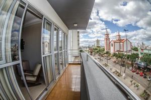 a balcony of a building with a view of a city at Hotel Desbravador in Chapecó