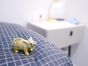 a small gold toy pig sitting on a table at Student Accommodation - 5 Man Cheong Street in Hong Kong