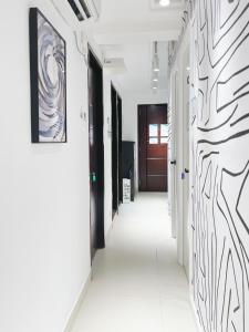 a hallway with black and white art on the walls at Student Accommodation - 5 Man Cheong Street in Hong Kong