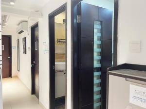 a corridor in a hospital with a door and a hallway at Student Accommodation - 5 Man Cheong Street in Hong Kong