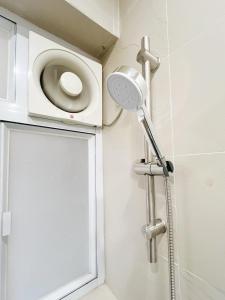 a shower with a shower head in a bathroom at Student Accommodation - 5 Man Cheong Street in Hong Kong