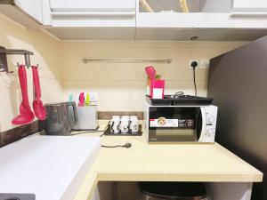a kitchen with a counter with a microwave on it at Student Accommodation - 5 Man Cheong Street in Hong Kong