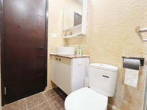 a bathroom with a white toilet and a sink at Student Accommodation - 5 Man Cheong Street in Hong Kong