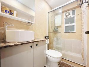 a bathroom with a toilet and a glass shower at Student Accommodation - 5 Man Cheong Street in Hong Kong