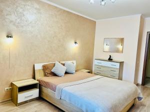 a small bedroom with a bed and a dresser at Apartaments Sichovyh Strilciv 68a in Ivano-Frankivsʼk