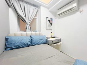 a bedroom with a blue bed and a window at Student Accommodation - 5 Man Cheong Street in Hong Kong