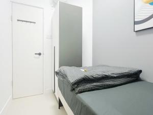 a bed in a room with a door and a bed sidx sidx sidx at Student Accommodation - 5 Man Cheong Street in Hong Kong