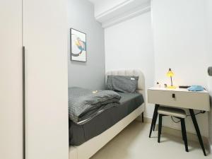 a small bedroom with a bed and a desk at Student Accommodation - 5 Man Cheong Street in Hong Kong