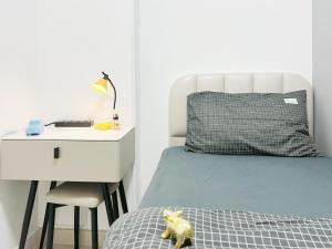 a bedroom with a bed with a night stand and a desk at Student Accommodation - 5 Man Cheong Street in Hong Kong