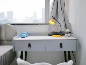 a white dresser in a room with a window at Student Accommodation - 5 Man Cheong Street in Hong Kong
