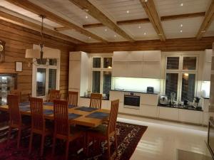 a kitchen and dining room with a table and chairs at Kuivakangas in Kuivakangas