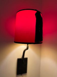 a red lamp with a tag attached to it at RIAD ENNAFOURA BOUTIQUE HOTEL in Marrakesh