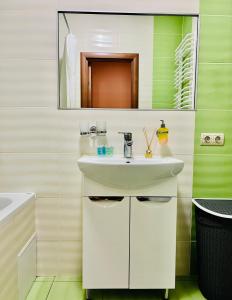 bagno con lavandino bianco e specchio di Apartaments Sichovyh Strilciv 68a a Ivano-Frankivsʼk
