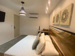 a bedroom with a bed and a pendant light at Maidy Luxury in Medellín