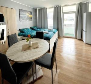 a living room with a table and a bed at Apartment in Neuss. 4 Personen in Neuss