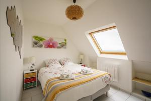 Saint-NicLes Océanes - Vue Mer的一间卧室，里面有一张床和一扇窗户。