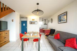 Saint-NicLes Océanes - Vue Mer的客厅里有一张沙发和一张桌子。