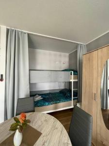 a room with a table and a bunk bed at Apartment in Neuss. 4 Personen in Neuss