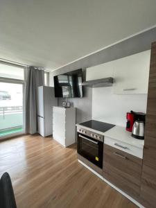 a kitchen with a stove and a refrigerator at Apartment in Neuss. 4 Personen in Neuss