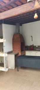 a patio with a table and a brick oven at BIMBA HOSTEL - UNIDADE 03 - GOIÂNIA - GO in Goiânia