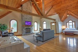 a large living room with a fireplace and a tub at Premier Cottages by Amish Country Lodging in Berlin